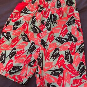 Nike Red and Black Shorts with Dynamic Swoosh Pattern